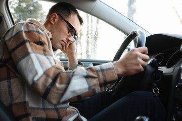 Tired driver sleeping in his modern car