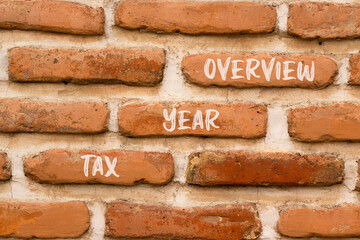Tax year overview symbol. Concept words Tax year overview on beautiful brown brick wall. Beautiful brown brick wall background. Business tax year overview concept. Copy space.