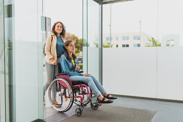 Young woman with cerebral palsy enters building with her personal assistant - They arrive together...