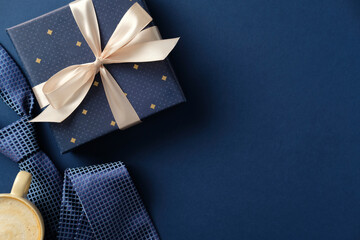 Father's Day gift box with tie and coffee on blue background. Perfect for masculine gift concepts.