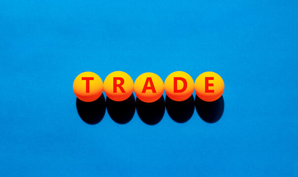 Trade symbol. Concept word Trade on beautiful yellow tennis ping pong balls. Beautiful wooden table wooden background. Business lifestyle trade concept. Copy space.