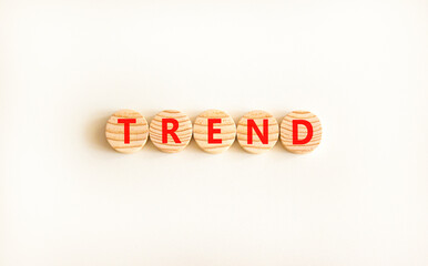 Trend and trending symbol. Concept word Trend on beautiful wooden circles. Beautiful white table white background. Business lifestyle trend and trending concept. Copy space.