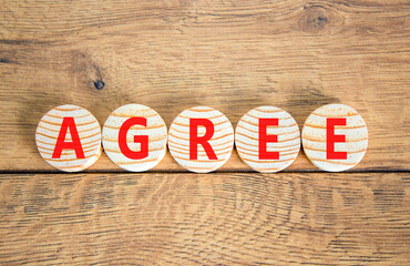 Agree symbol. Concept word Agree on beautiful wooden circles. Beautiful wooden table wooden...