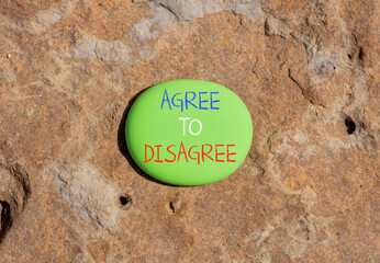 Agree to disagree symbol. Concept words Agree to disagree on beautiful green stone. Beautiful brown...