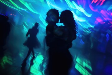 Silhouette of a couple kissing amidst vibrant, blurry neon lights at a dance party.