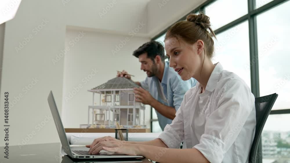 Poster professional engineer measure model while telling coworker about house design. young smart architect