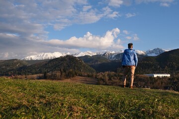 Fototapeta premium Silhouette of standing man in blue jacket on beautiful viewpoint with Tatras mountains on Antalowka, Zakopane, Poland