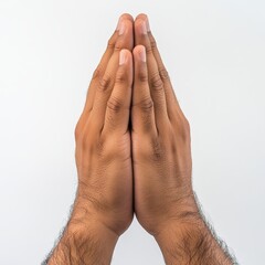 Male hands in a prayer position with palms pressed together against a plain white background