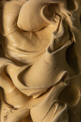 Caramel flavored gelato - full frame detail. Close up of a creamy caramel surface texture of ice...