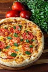 Pizza margherita, tomato, cheese and basil. Italian cuisine