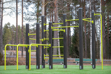 Fototapeta premium Empty outdoor gym. Sports simulators. Fitness equipment. Urban outdoor sports ground with weight training equipment for sports. Sports and recreation area. Street workout.