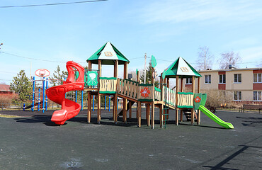 Naklejka premium Russia, Saint Petersburg, April 14, 2025. Children's playground with various play structures in a village in Russia, Leningrad region. Play structures of houses for sports development of children.