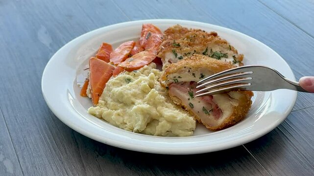 Eating a Plate of Chicken Condon Bleu