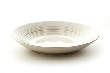 A low angle shot of an empty white ceramic bowl with concentric rings on a white background surface