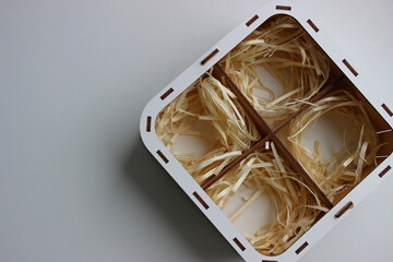 Wooden box with four compartments with bundles of wood shavings inside each. Souvenir box made of...