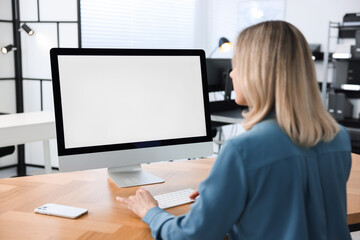 Woman working on computer at table in office. Mockup for design