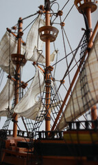 The deck of a three-masted pirate ship with sails and rigging. Deck ropes and sail ropes on the...