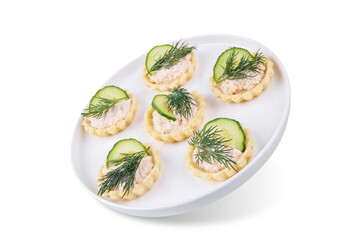 Salmon mousse tartlets in a plate on a white isolated background