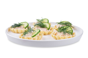 Salmon mousse tartlets in a plate on a white isolated background