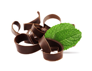 Milk chocolate curls and mint leaves on white background