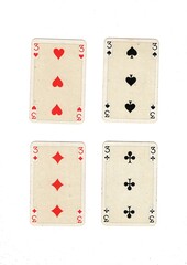 A hand of antique playing cards showing four of the same value.