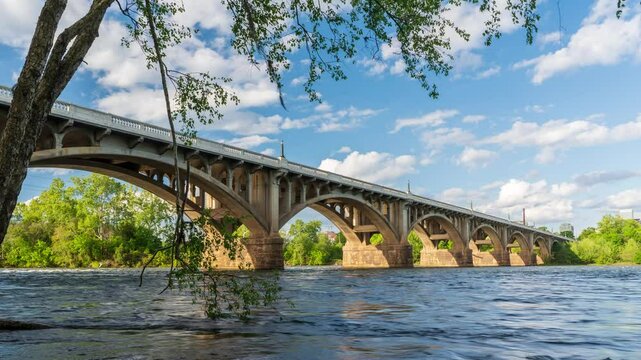 Timelapse of the Gervais Street Bridge entering Columbia, South Carolina, with a broken tree in the foreground.