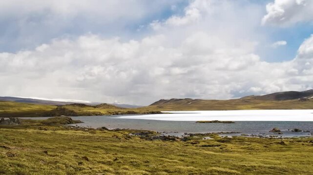 A time-lapse of Arabel Plateau in Kyrgyzstan, showing a frozen lake surrounded by meadows, with clouds passing overhead and the landscape changing through the day&rsquo;s natural light
