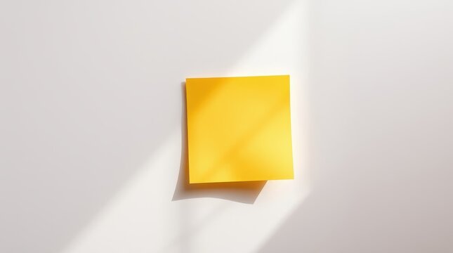 Yellow Sticky Note with Shadow on White Wall