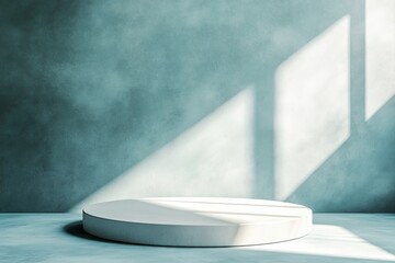 White circular platform against a textured blue wall with window light shining on the surface