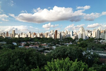 View of Sao Paulo skyline with urban greenery and vibrant clouds