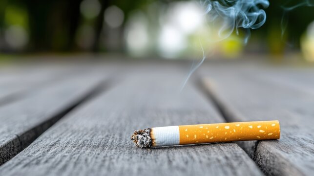 Close Up of Cigarette on Wooden Surface with Smoke Rising in Natural Outdoor Setting - Powered by Adobe