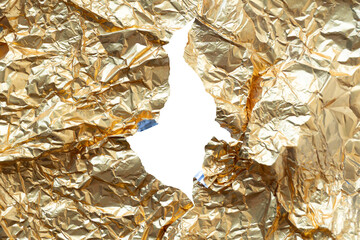 A piece of crumpled metallic gold foil torn in the center, revealing a blank white space...