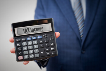 Accountant holding calculator with tax income