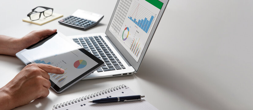 Man using tablet and laptop, financial app
