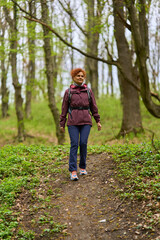 Woman hiking on forest trail