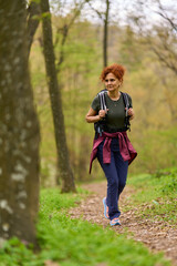 Woman hiking in spring forest