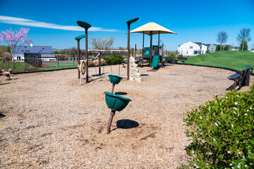 Outdoor playground with swings and slides and soft malch flooring.