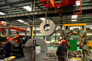 Workers on the production line of the strip steel coil factory are working