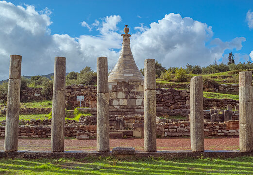 Archaeological site of Ancient Messene, UNESCO World Heritage, Peloponnese, Greece, Ancient columns and tholos tomb under a cloudy sky