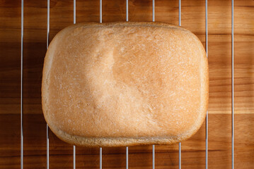 Overhead shot of a freshly baked bread loaf on cooling rack