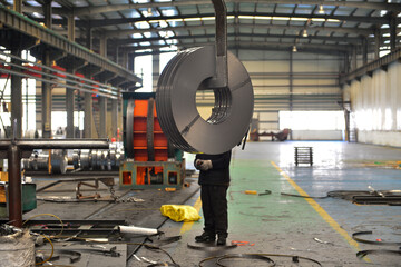 Workers on the production line of the strip steel coil factory are working