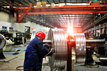 Workers on the production line of the strip steel coil factory are working