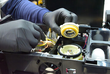 Professional repair and cleaning technician for coffee machine parts with a sprocket grinder for whole bean and espresso, both commercial and home. Internal parts. Boiler. Cleaning.