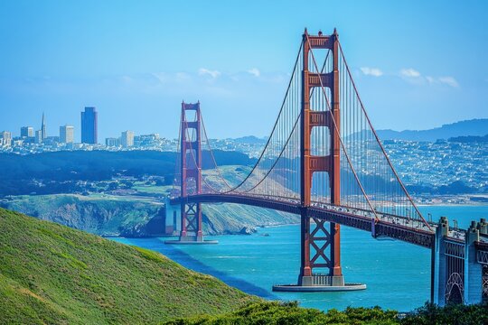 The Golden Gate Bridge stretches across the bay, its iconic red hue standing out against the San Francisco skyline.