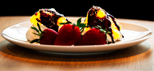 Ice Cream with chocolate sauce, sprinkles and strawberries 