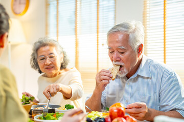Happy Asian family senior parent and adult child celebration holiday dinner party at home. Couple...