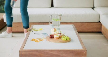 Senior woman arranging items on white table at home, celebrating recovery with pitcher, copy space