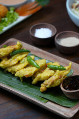 Golden Fried Tempeh Mendoan with Green Chili and Dipping Sauce on Banana Leaf