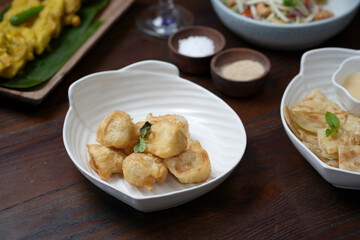 Crispy Banana Fritters Served in a Modern Ceramic Dish