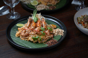 Classic Shrimp Pad Thai Served on Banana Leaf with Traditional Garnishes